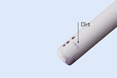 The picture shows a nozzle that has not been cleaned with EWater+. Dirt is still visible on this nozzle. 