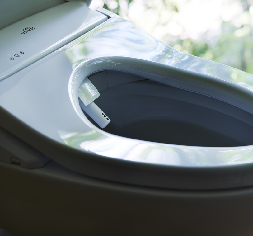 A WASHLET® with opened lid and extended nozzle