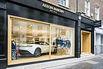 View into a shop window in which a white sports car is presented