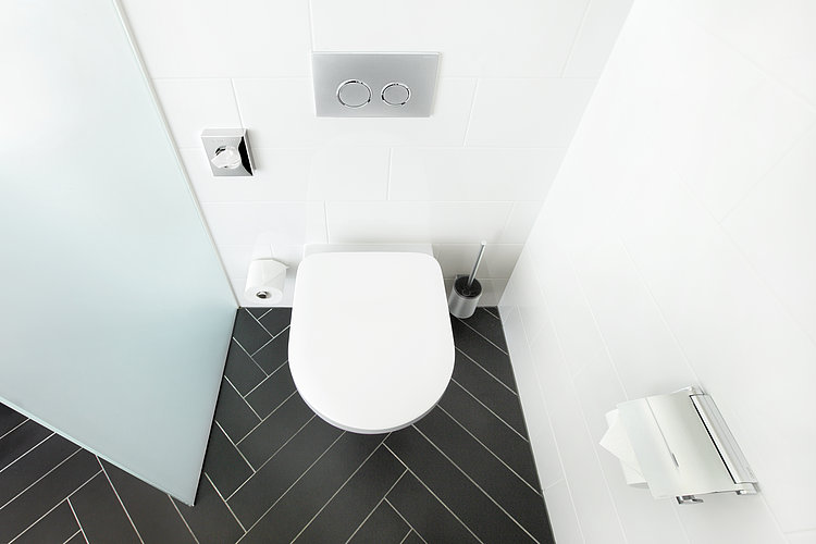 Hotelzimmer mit randloser Toilette und geöffneter Badezimmertür